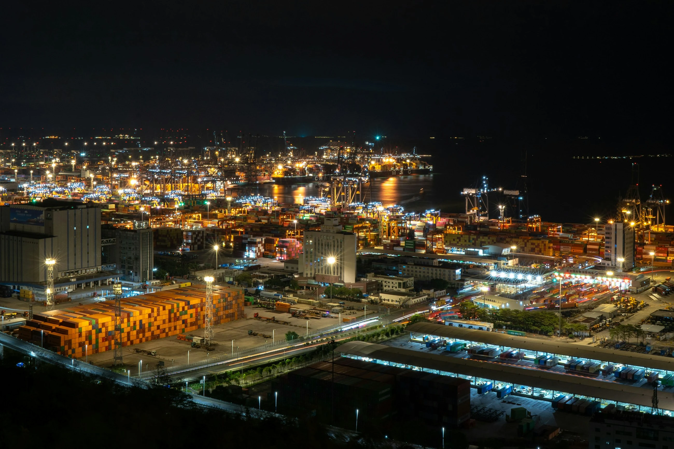 Yantian Port in Shenzhen at night, with illuminated container terminals, cranes and cargo ships